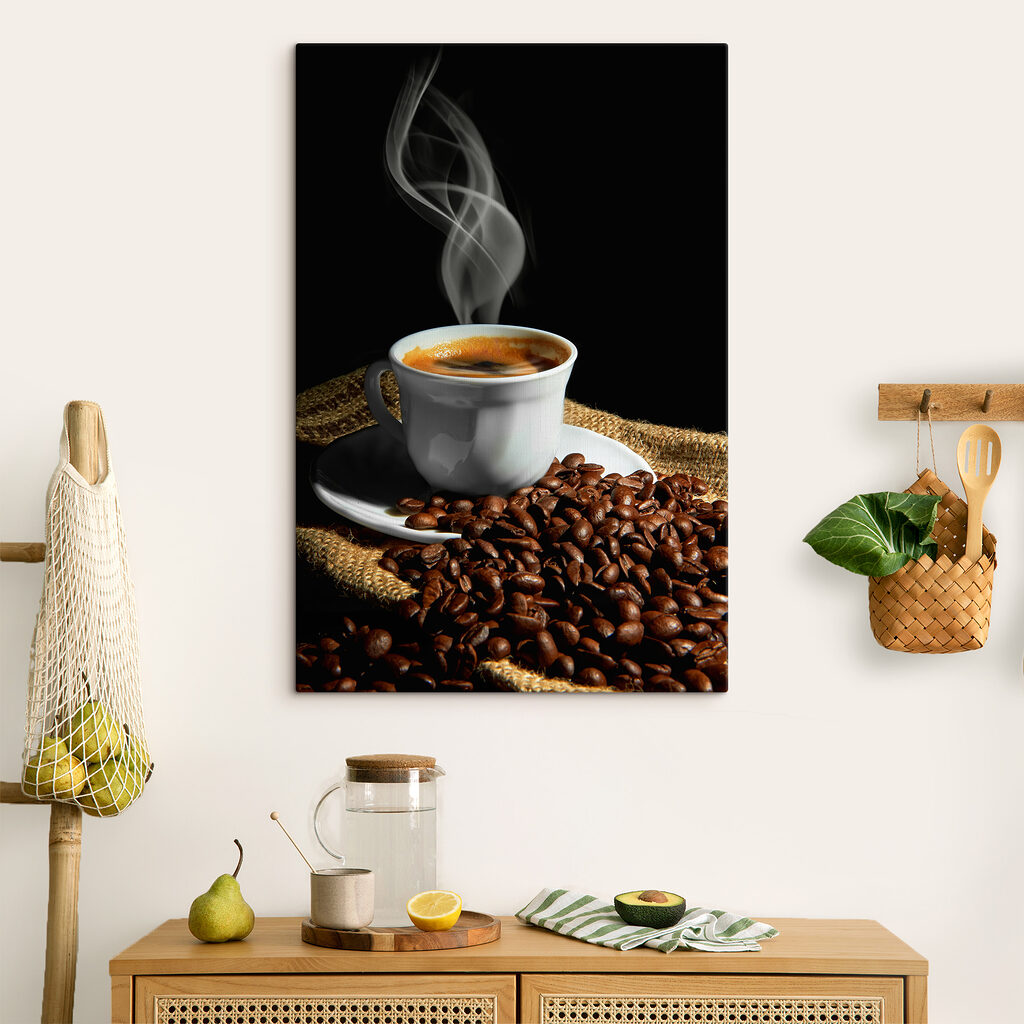A cup of coffee with smoke on a saucer and beans